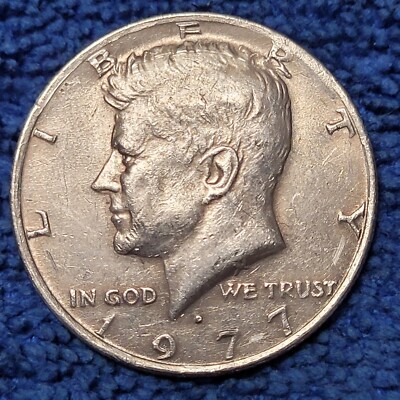 Reverse of 1977 Kennedy half dollar showing the area near eagle tail feathers where FG designer initials are absent in the No FG variety