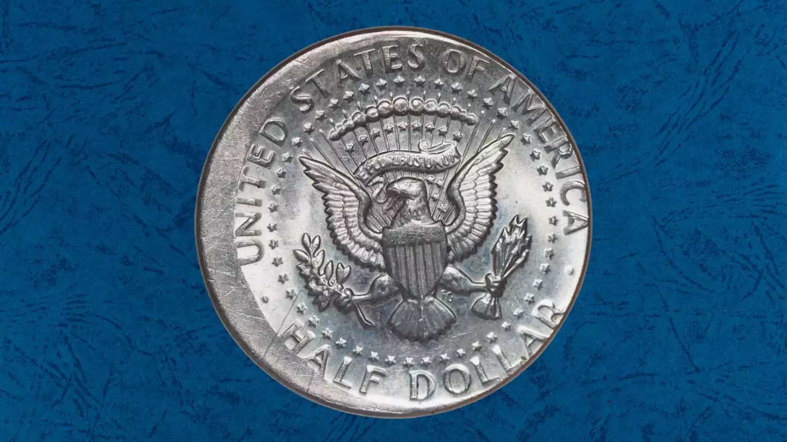 1977 Kennedy half dollar off-center strike error showing design shifted with blank crescent of unstruck planchet