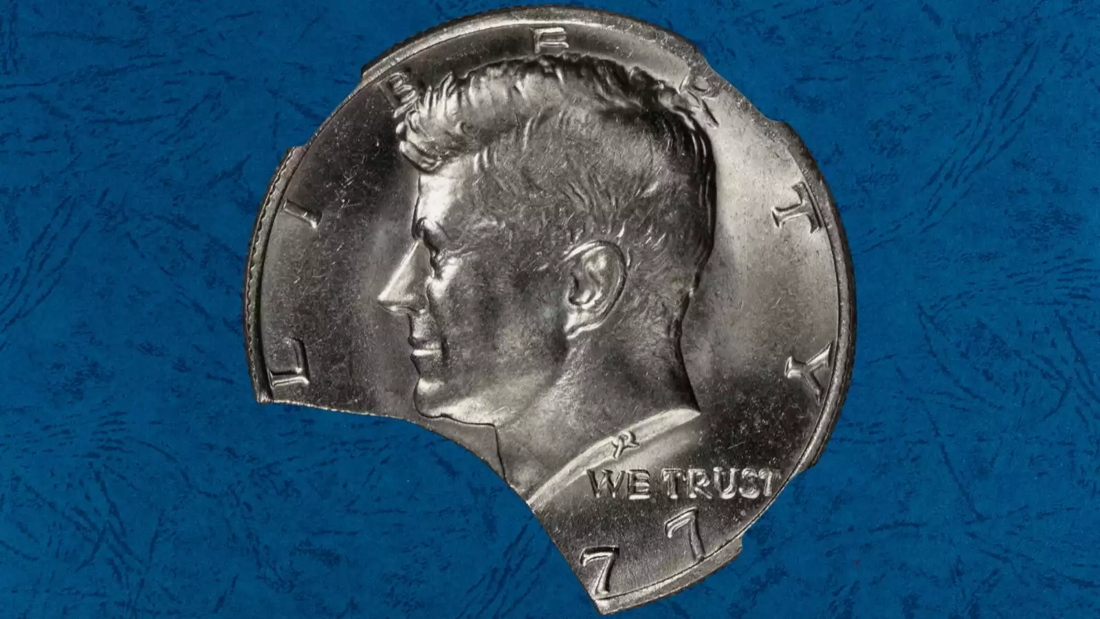 1977 Kennedy half dollar clipped planchet error showing curved notch cut into the coin rim